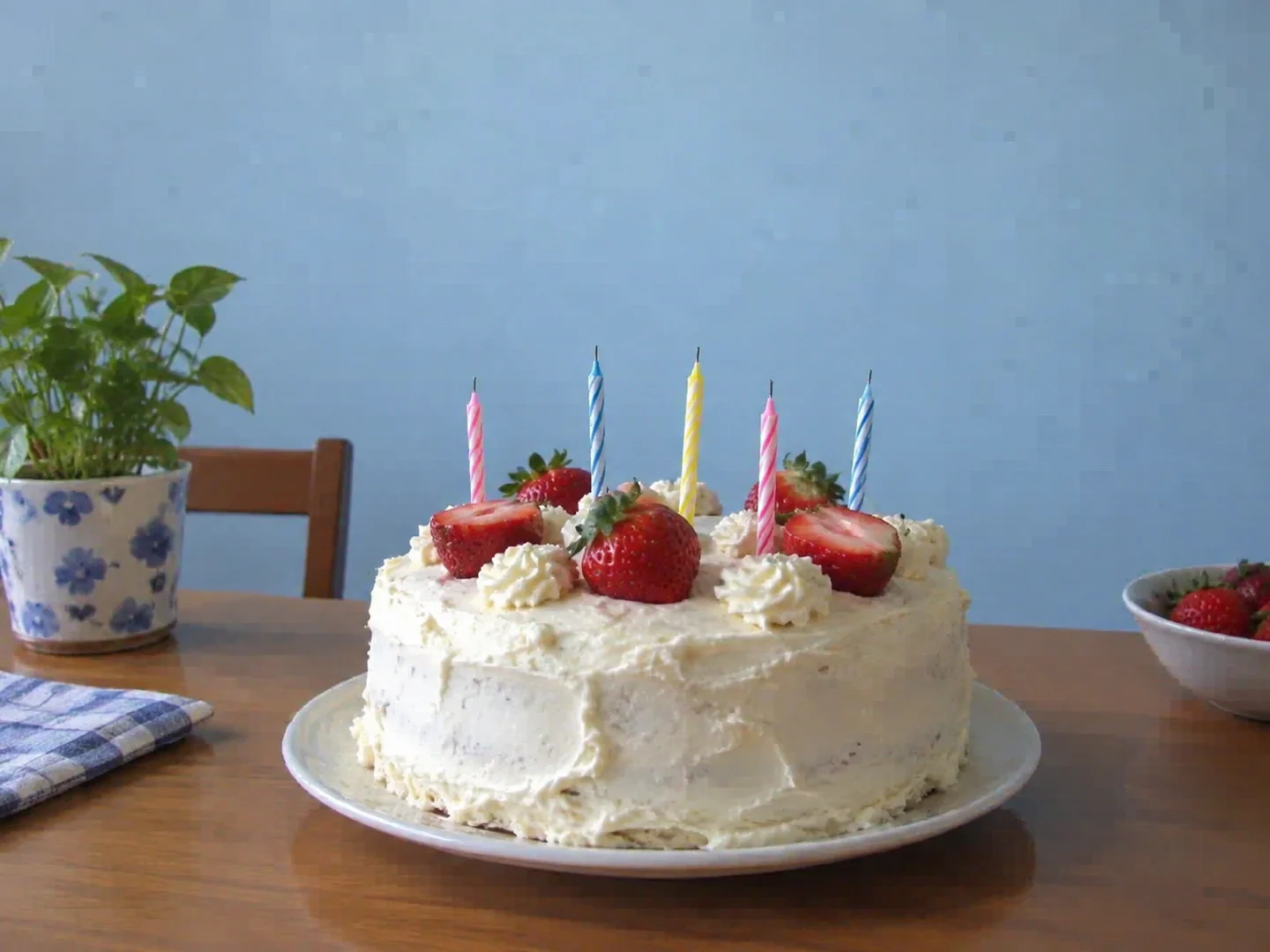 Birthday cake snapshot with blocky compression patches on the wall and frosting