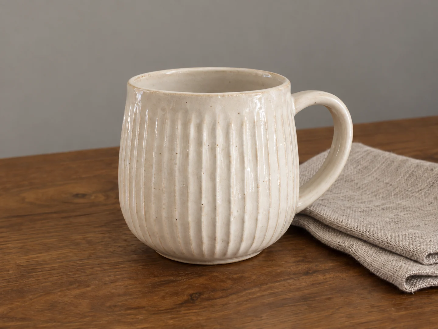 The same ceramic cup with neutral ivory color and clearer ribbed texture